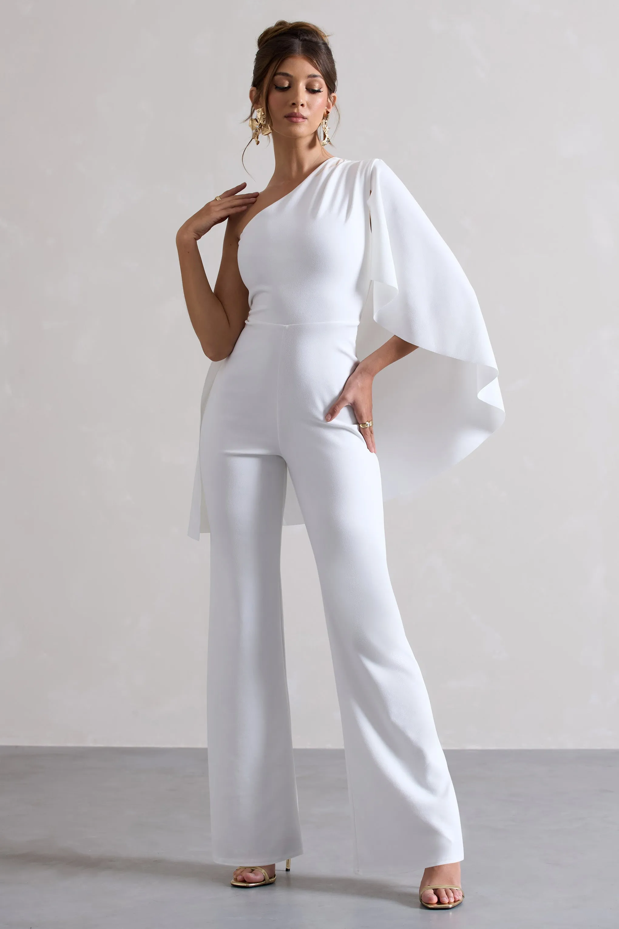 Pristine | White One Shoulder Cape Sleeve Flared-Leg Jumpsuit sold by Club L London