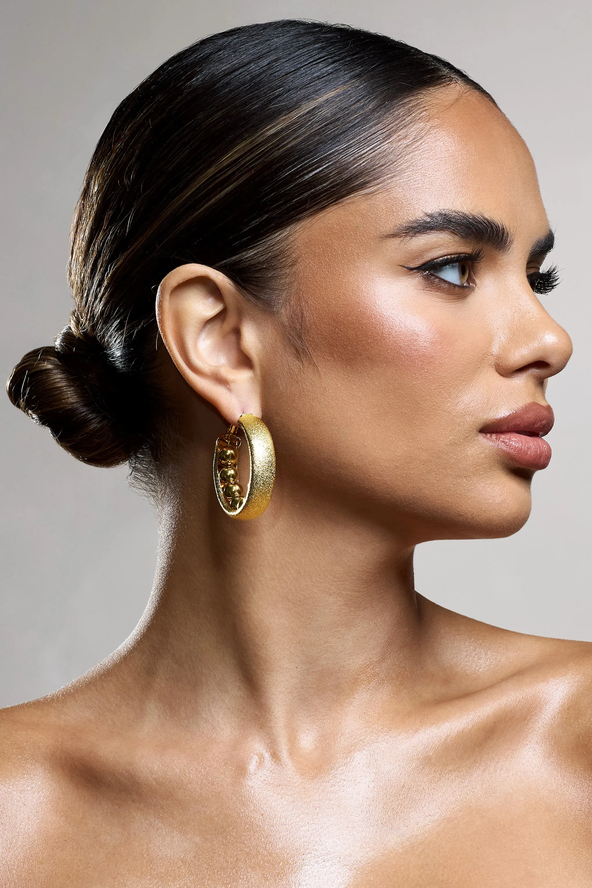 Portal | Gold Textured Chunky Hoop Earrings sold by Club L London