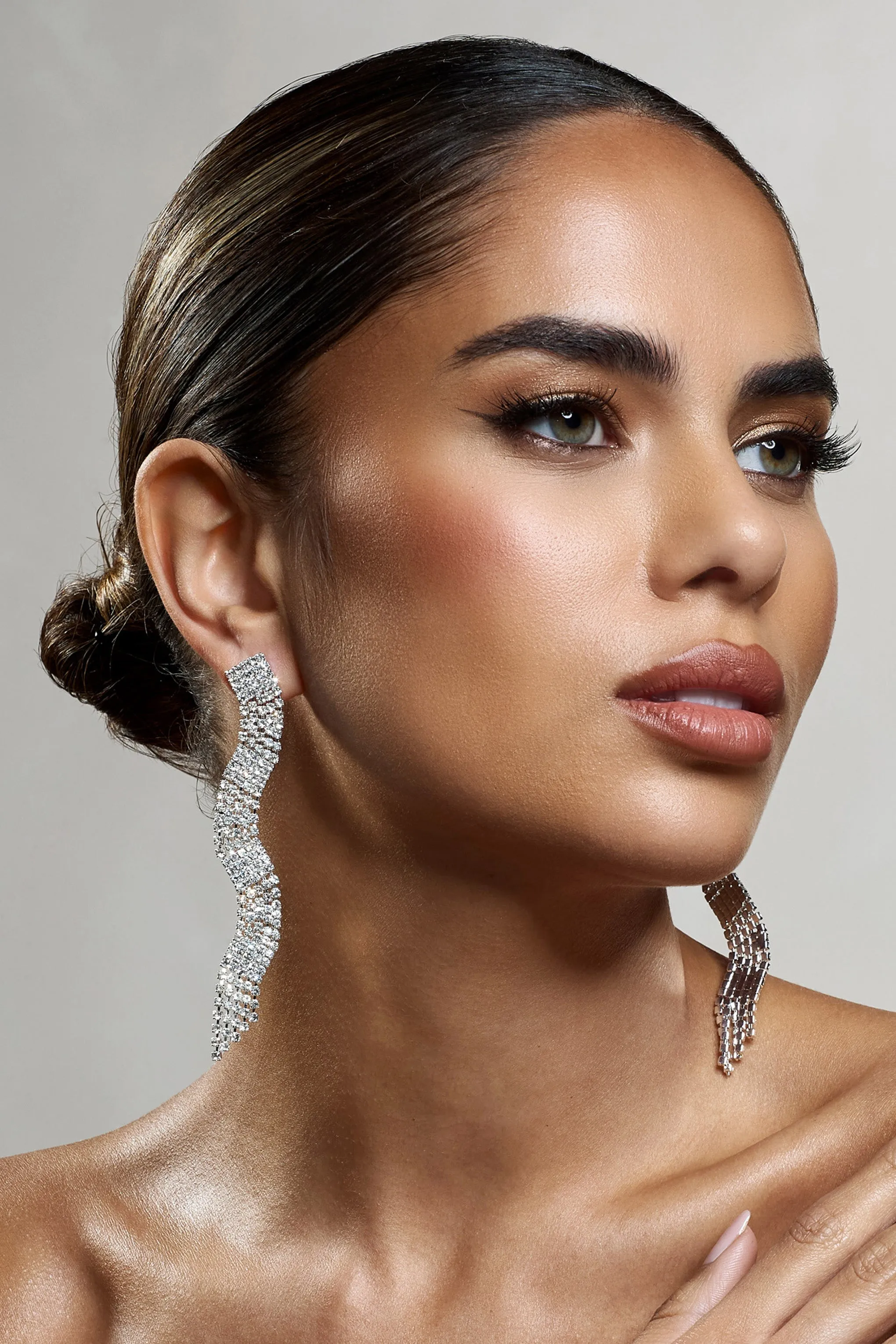 Swirl | Silver Diamante Curve Tassel Earrings sold by Club L London