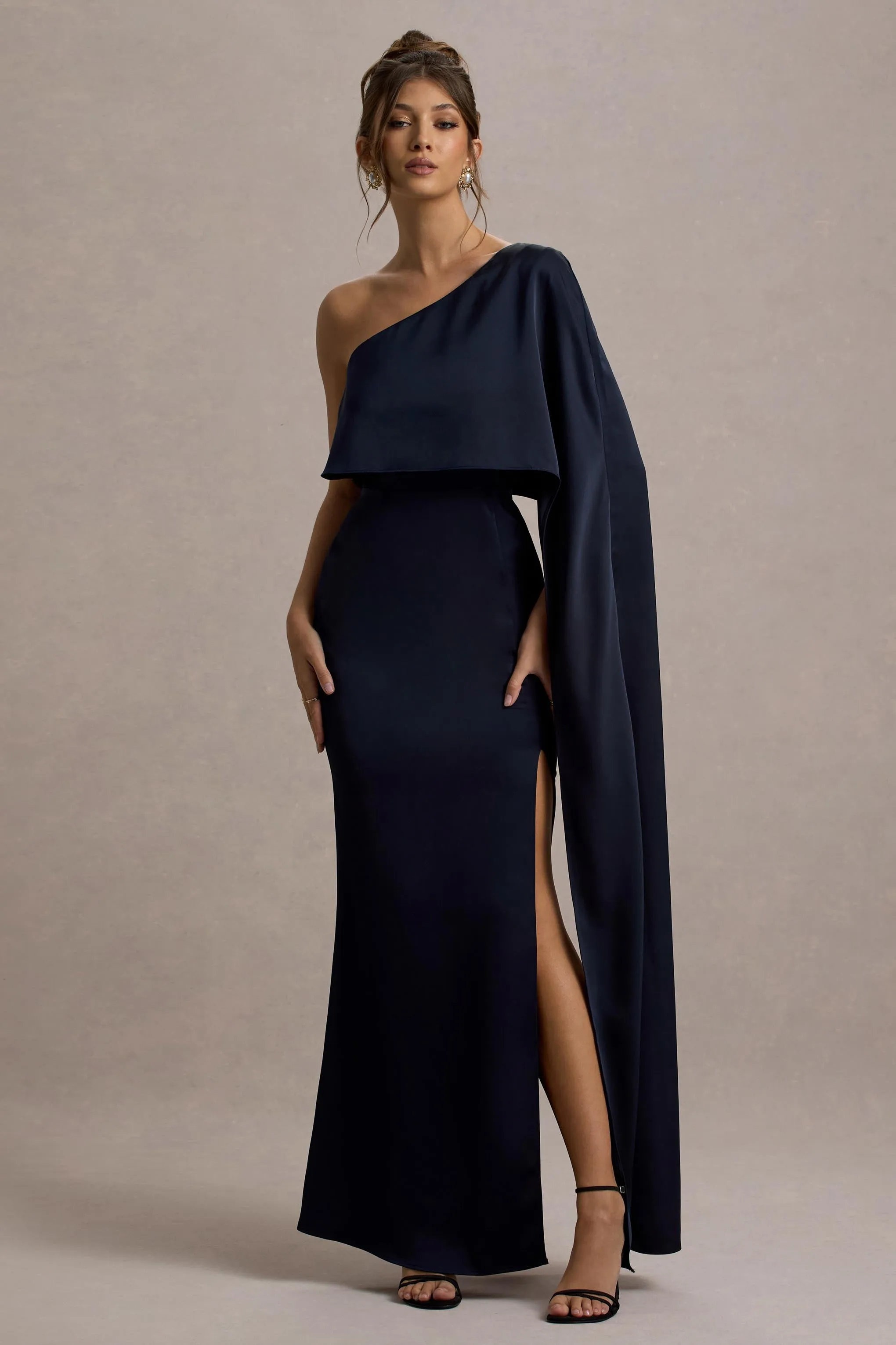 Amora | Navy Satin Asymmetric Cape-Sleeve Split Maxi Dress sold by Club L London