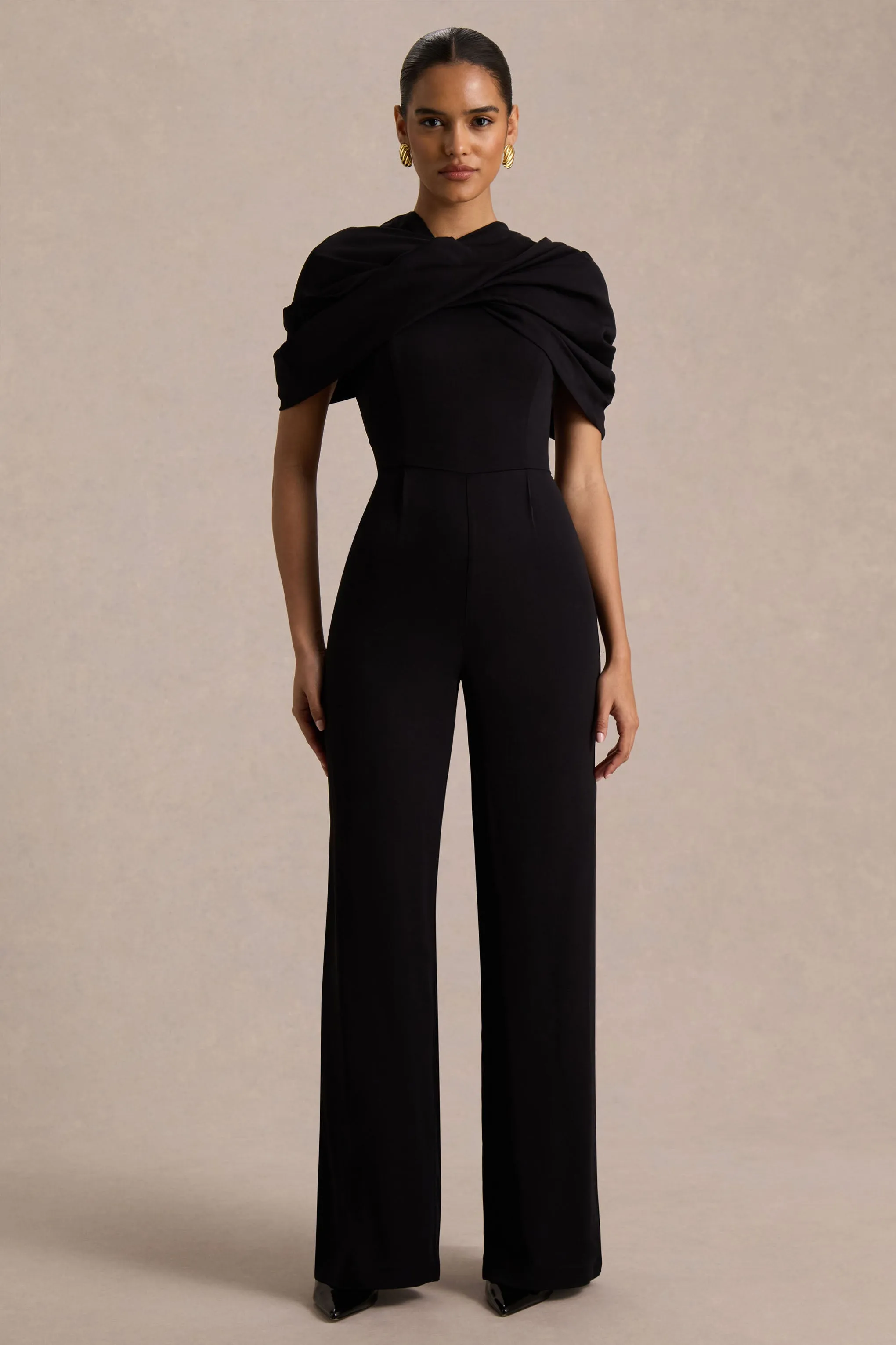 Raquel | Black Asymmetric-Neck Jumpsuit With Twisted Cape Detail sold by Club L London