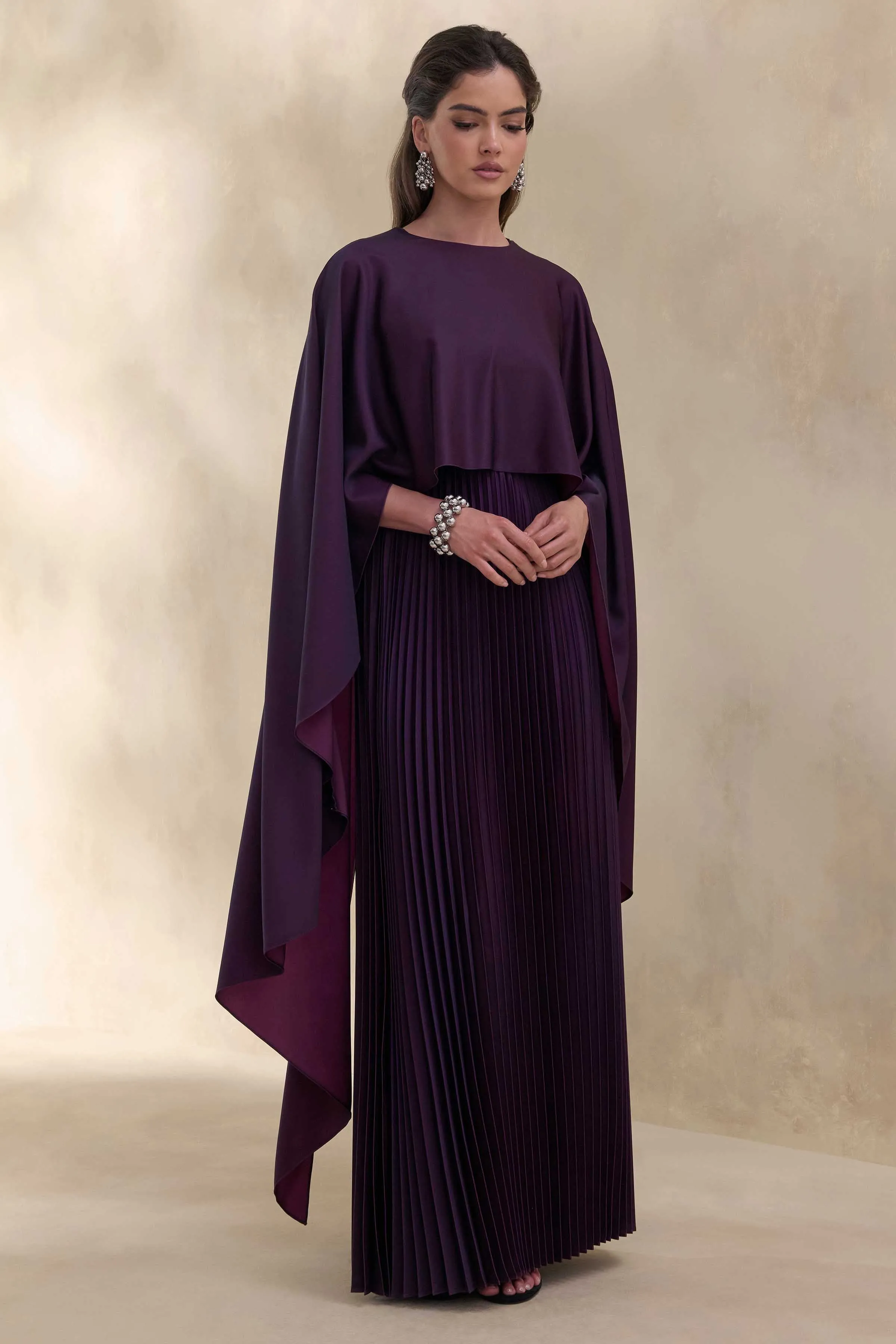 Loradia | Dark Plum Satin Round-Neck Maxi Dress With Cape-Sleeves And Pleated-Skirt sold by Club L London