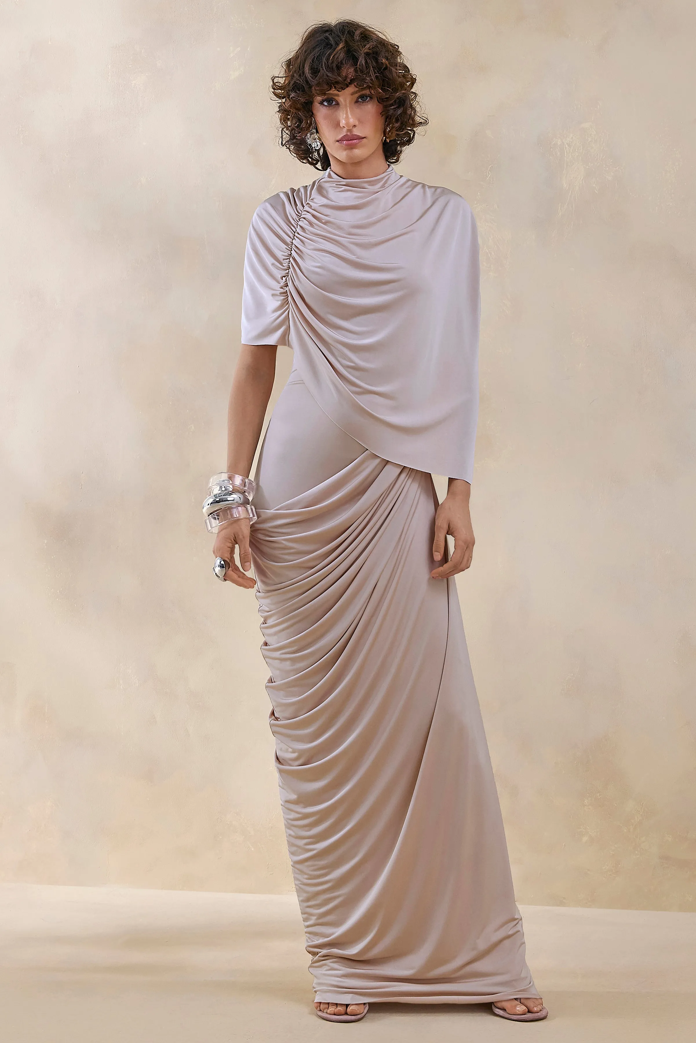 Lunaline | Champagne High-Neck Maxi Dress With Asymmetric Cape And Draped-Detailing sold by Club L London