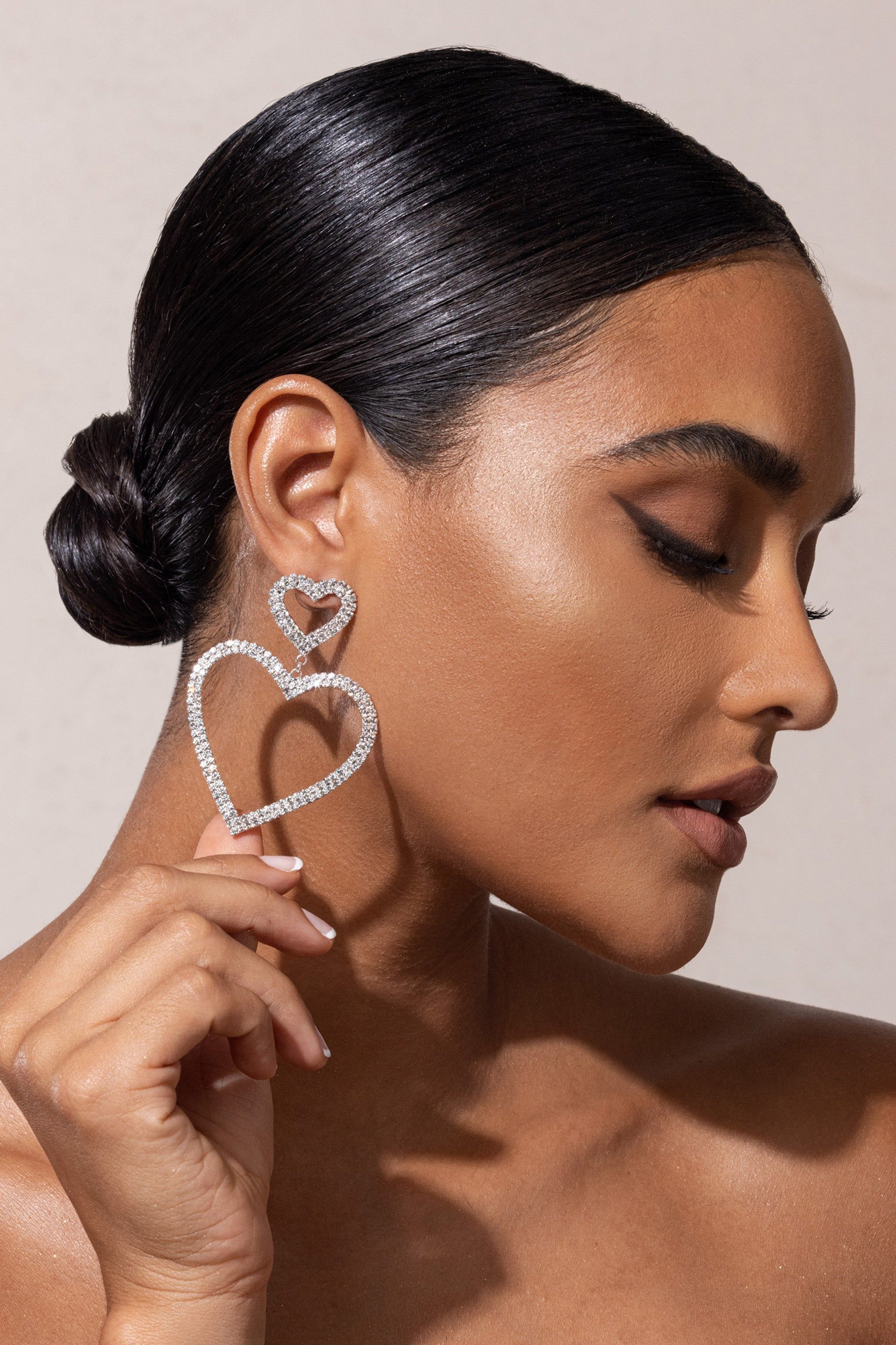 Luisa | Silver Diamante Heart Shape Drop Earrings sold by Club L London
