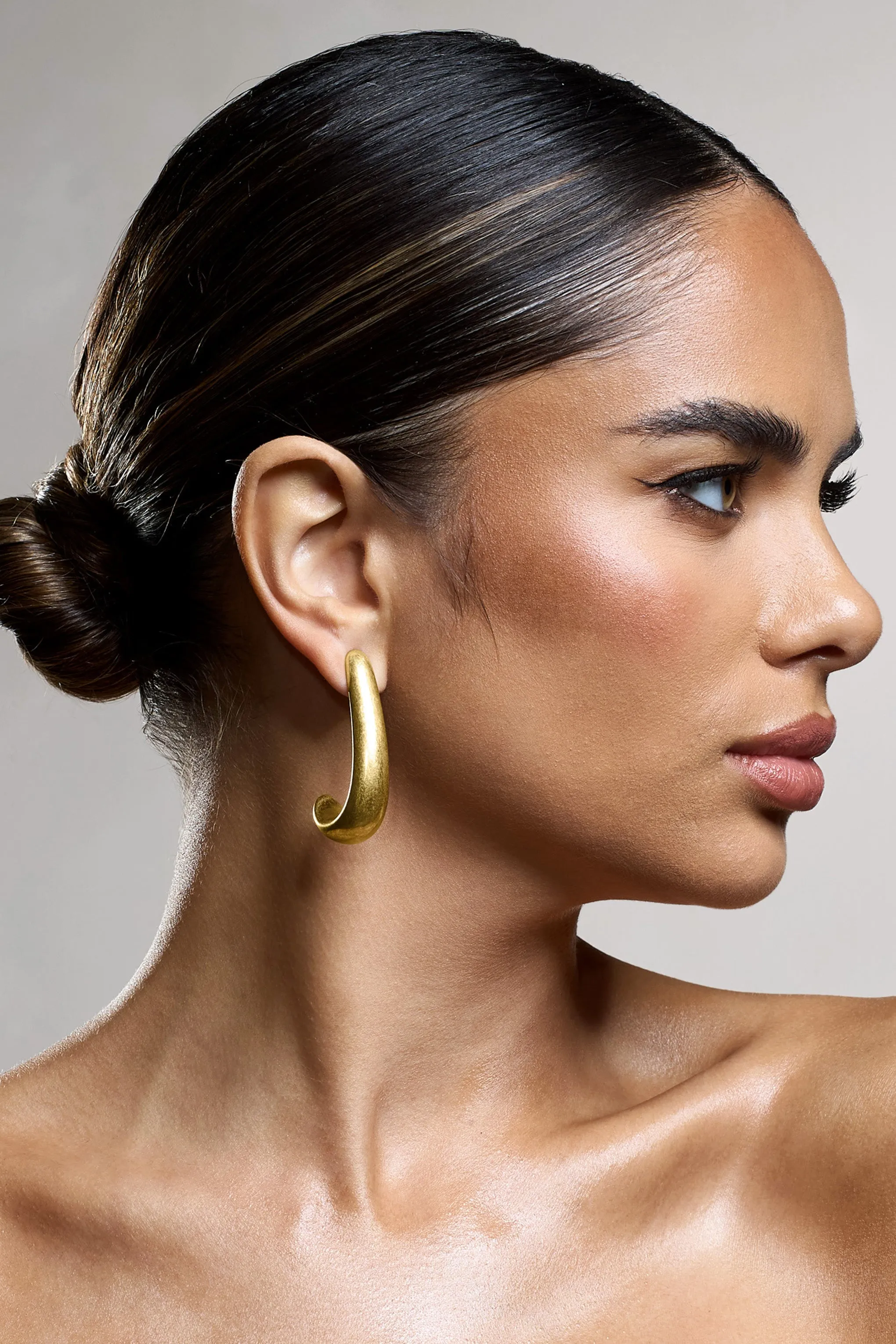 Zariah | Gold Curve Earrings sold by Club L London