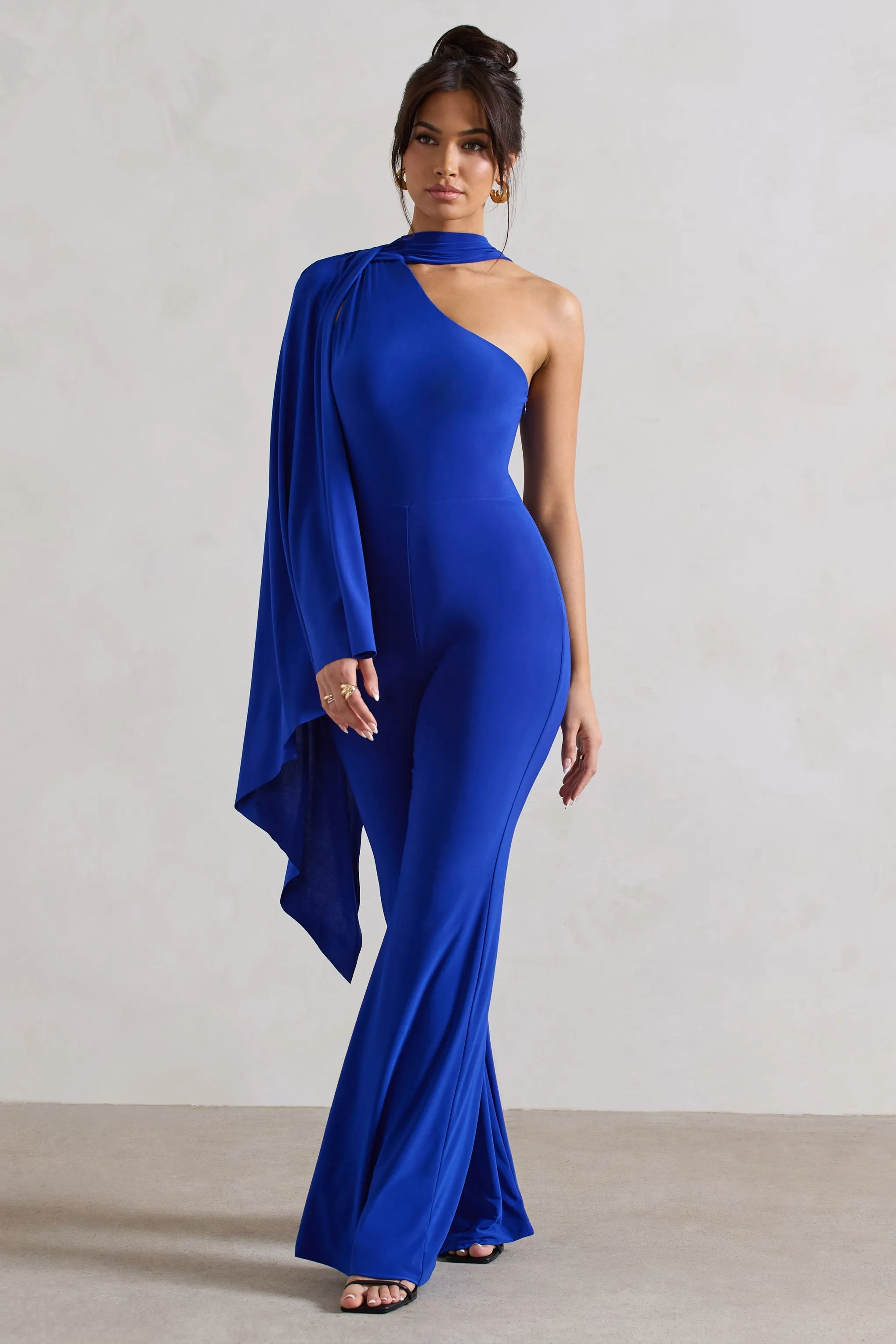 Offset | Royal Blue Asymmetric Flared-Leg Jumpsuit With Cape Sleeve sold by Club L London