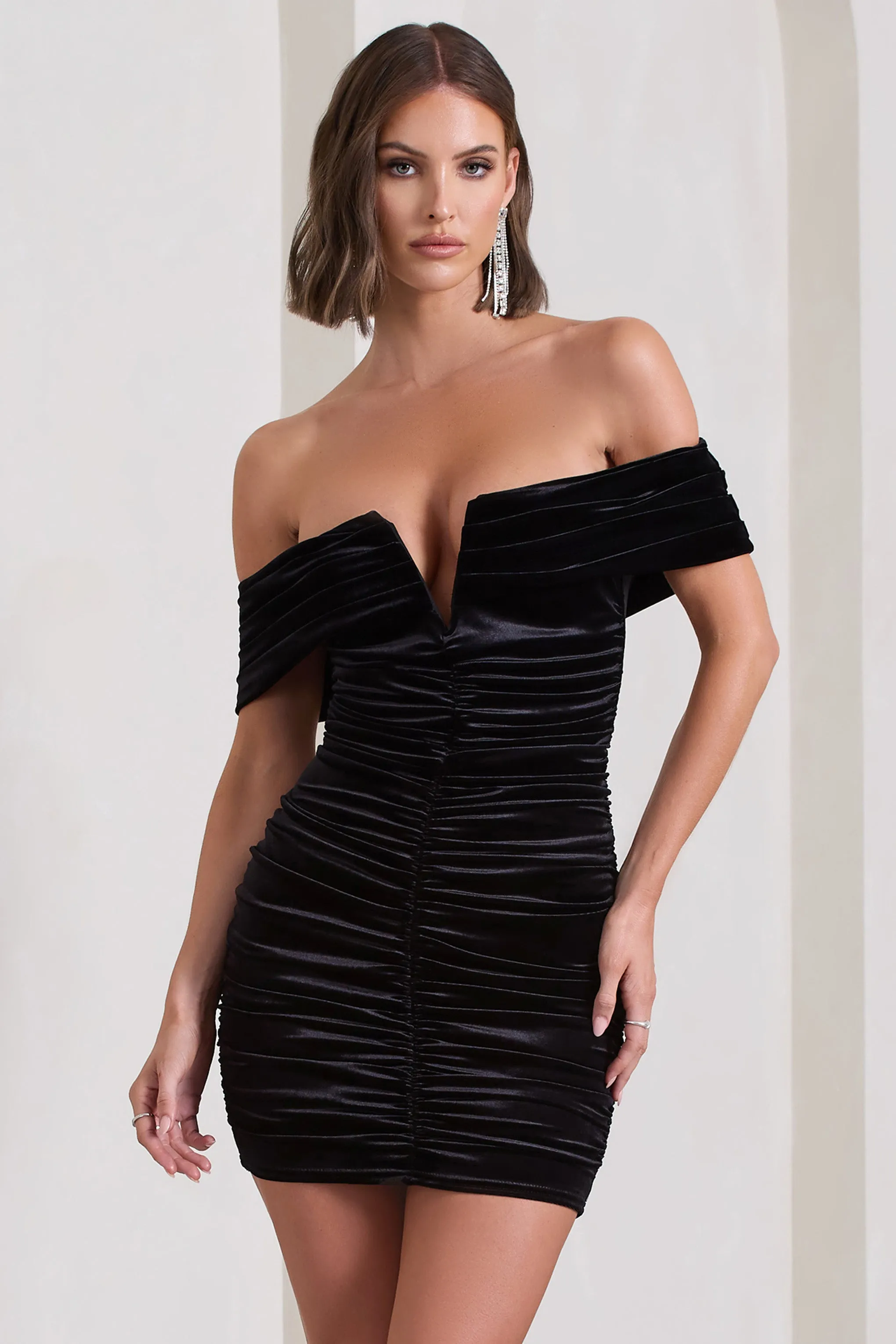 Little Glint | Black Velvet Ruched Bardot V-Neck Mini Dress sold by Club L London