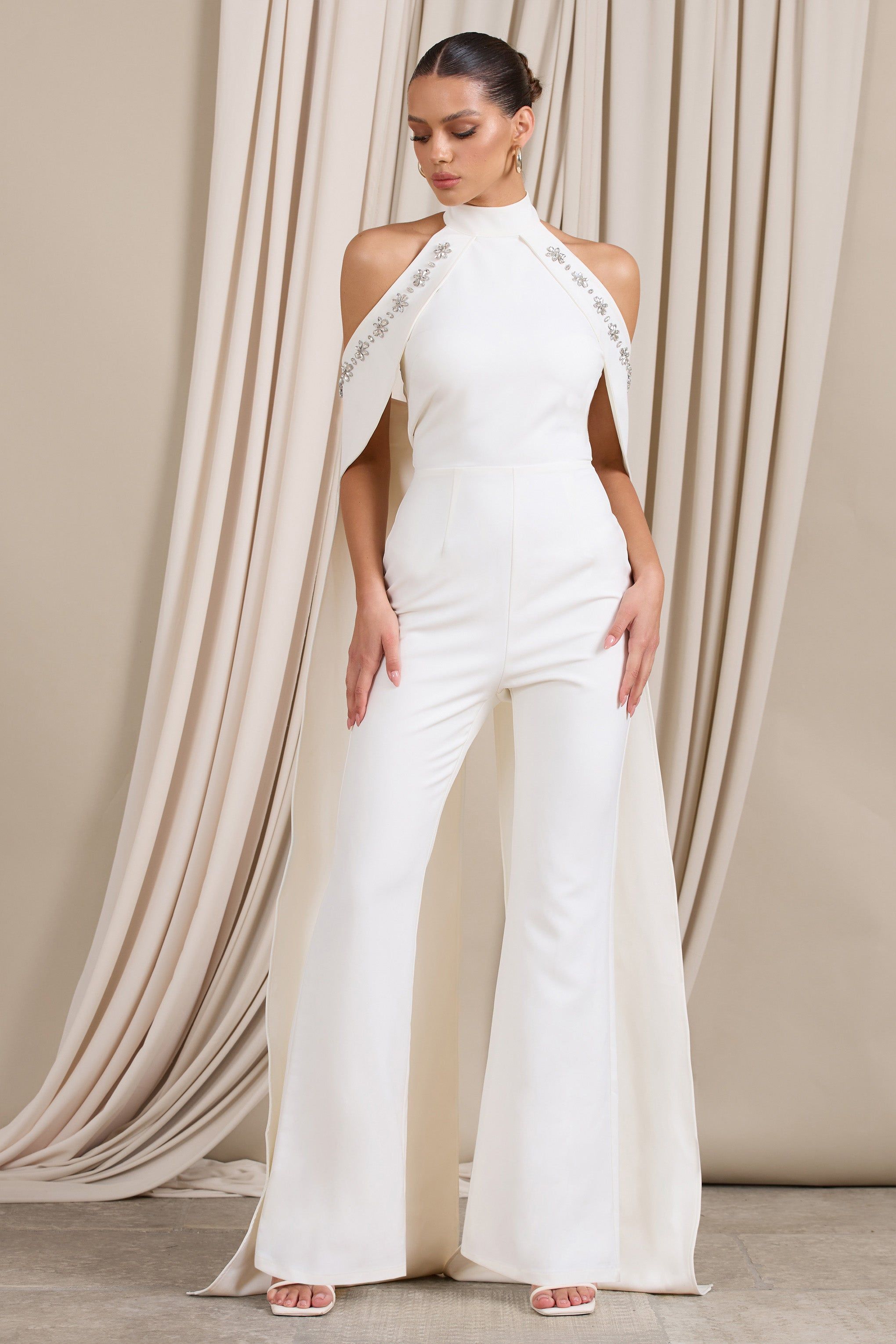 Angel | White High Neck Jumpsuit with Cold Shoulder Cape Sleeves sold by Club L London