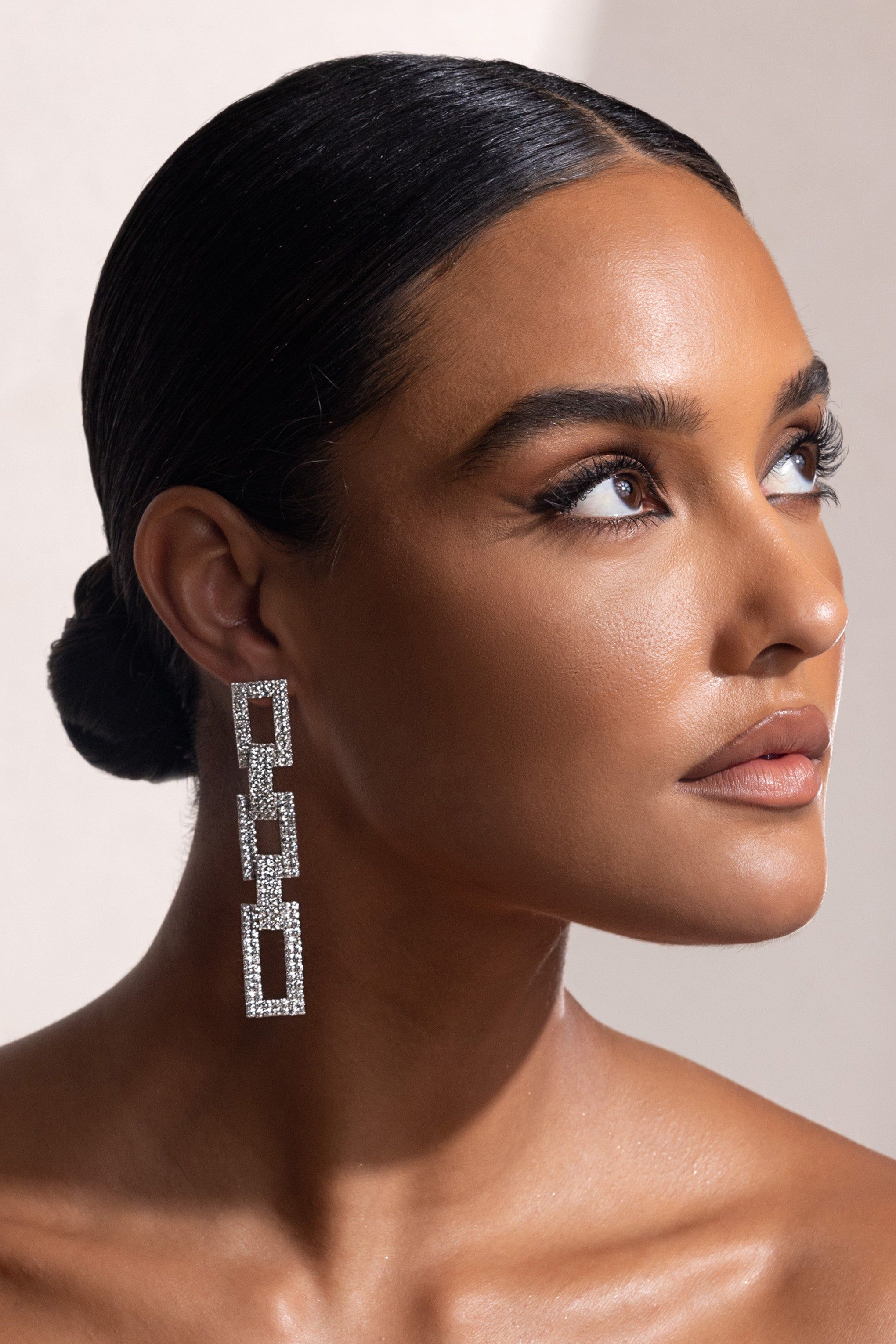 Pasqualina | Silver Diamante Chain Drop Earrings sold by Club L London