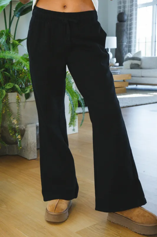 Simone Mid Rise Wide Leg Sweatpants, Black sold by North & Main Clothing Company
