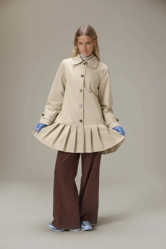Patter Pleat Trench Coat in Classic Beige sold by Sisters and Seekers