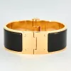 HERMES - Bracelet charnière modèle large plaqué or rose et émail noir sold by 58 Facettes