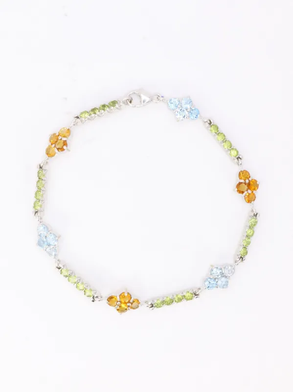 Bracelet ligne or blanc citrines péridots topazes bleues sold by 58 Facettes