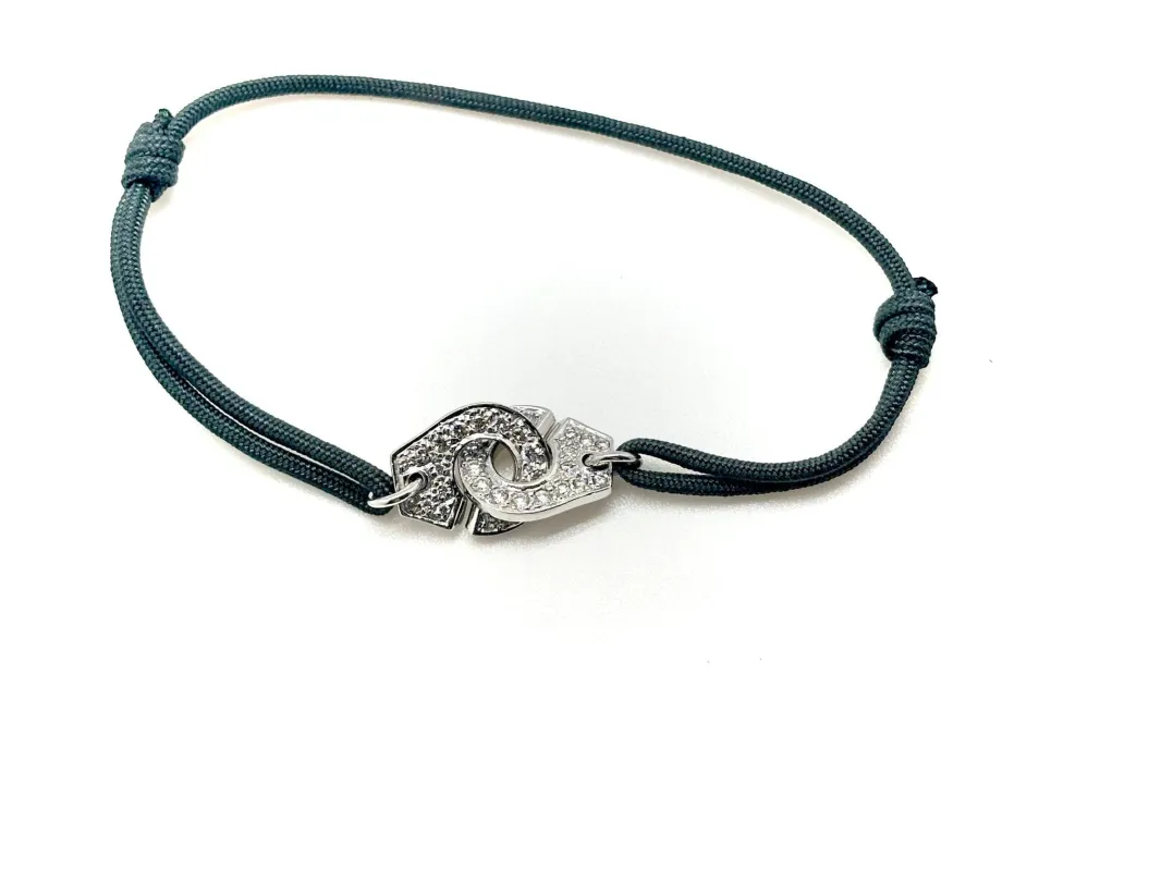 DINH VAN - Bracelet Menottes R12 avec diamants, sur cordon sold by 58 Facettes
