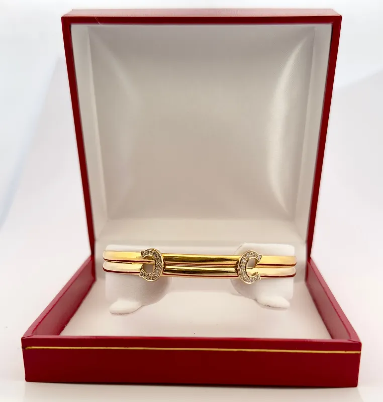 Bracelet Cartier vintage double C , 2 ors et diamants sold by 58 Facettes