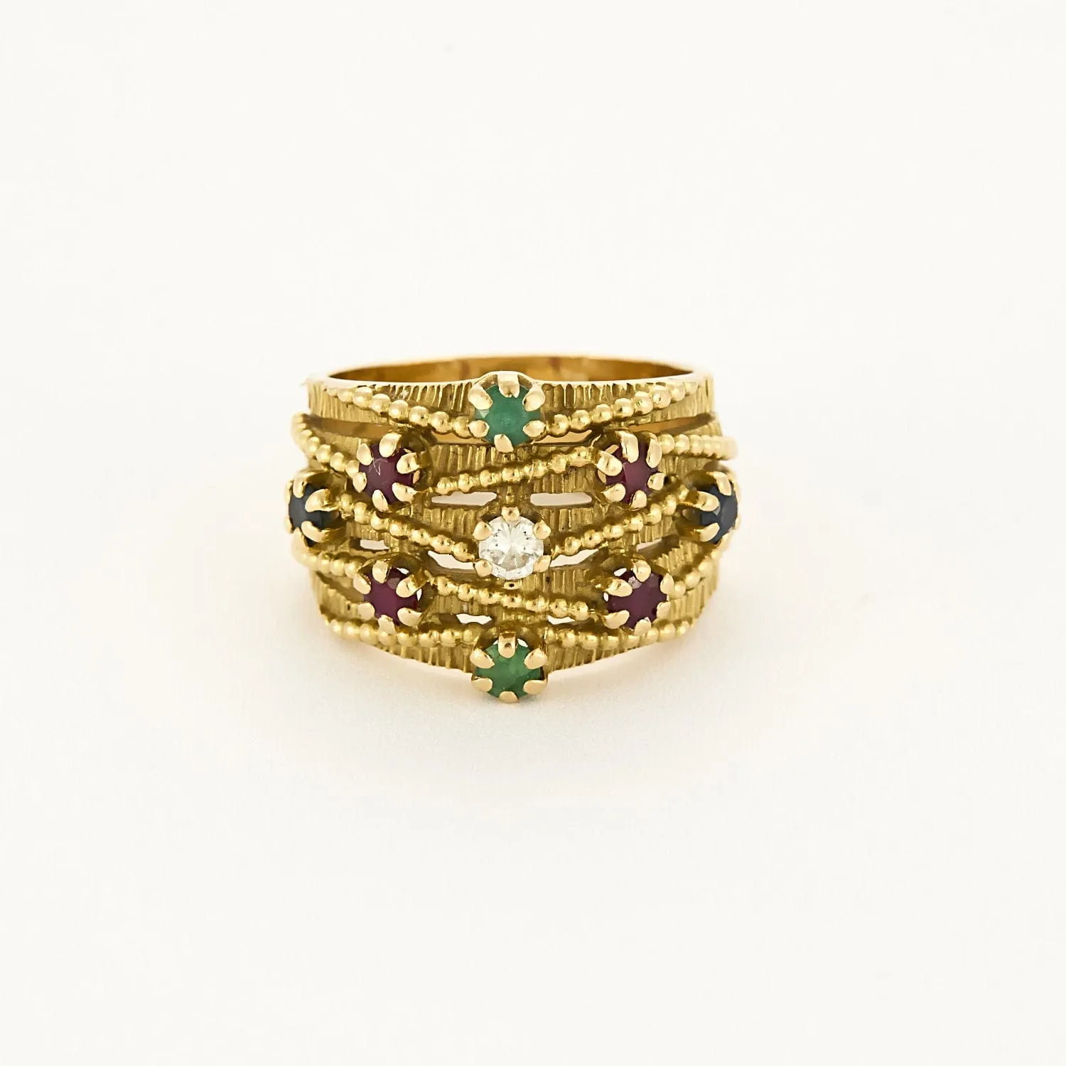 Bague bandeau mouvementée, or jaune, rubis, émeraudes et saphirs sold by 58 Facettes