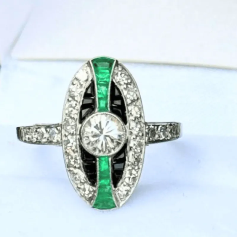 Bague de style Art Déco en platine avec diamants, émeraudes et onyx. sold by 58 Facettes