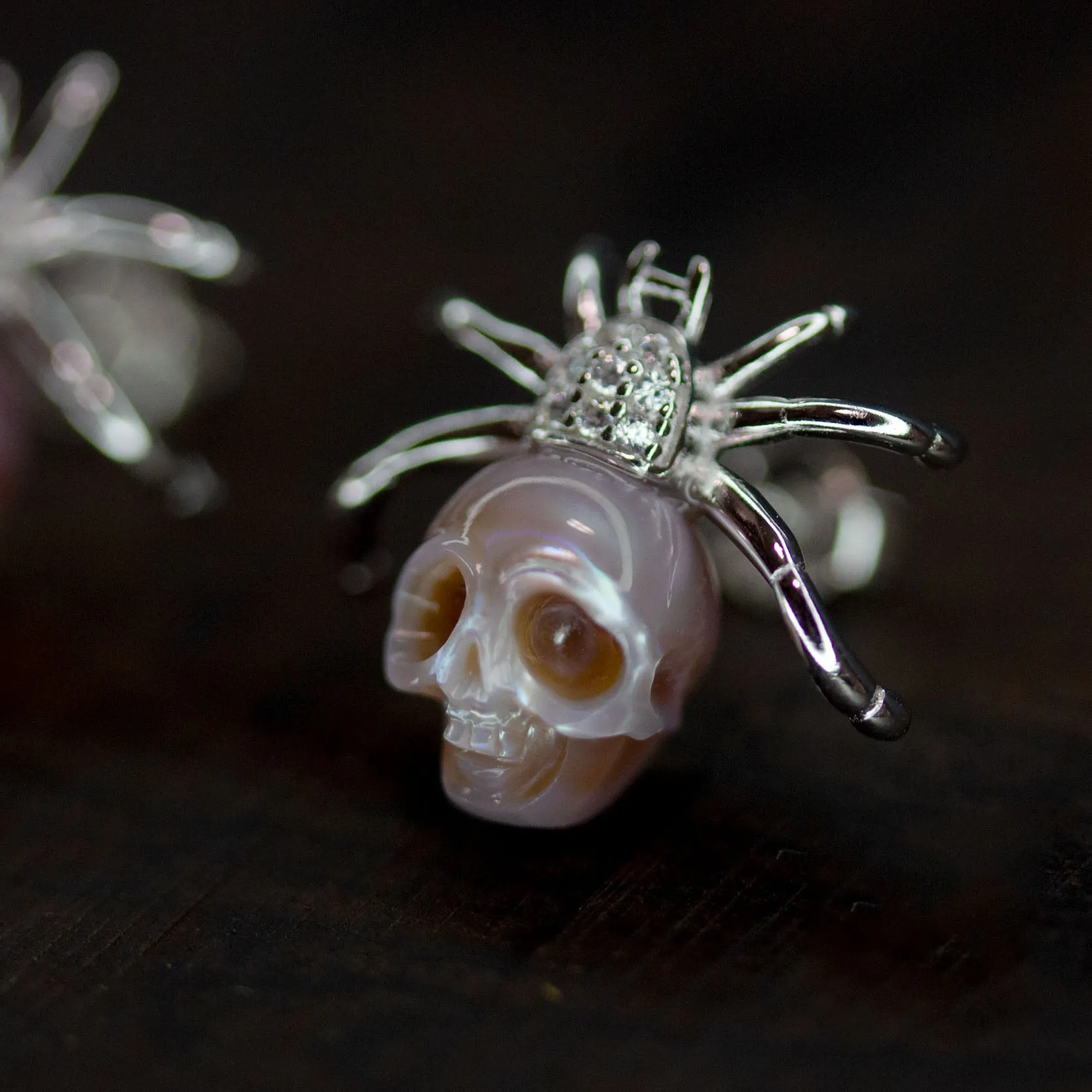 Hand-Carved Pearl Skull Spider Stud Earrings sold by Belle Juri