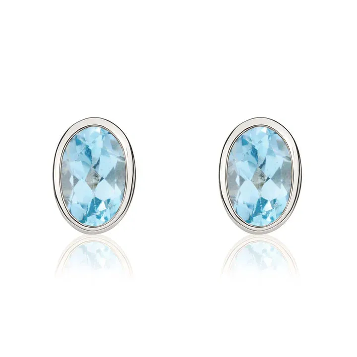 9ct White Gold 6x4 Oval Swiss Blue Topaz Rubover Stud Earrings sold by C.W. Sellors