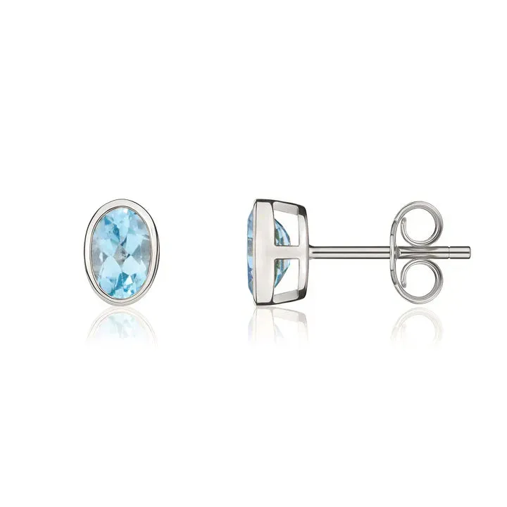 9ct White Gold 6x4 Oval Swiss Blue Topaz Rubover Stud Earrings sold by C.W. Sellors product image thumbnail 2