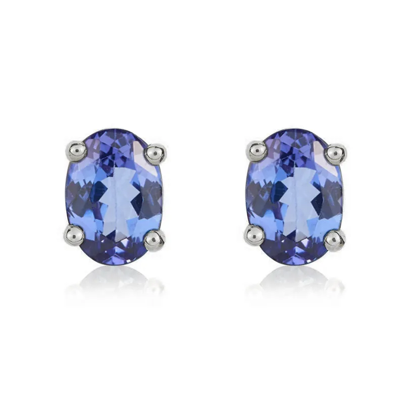 9ct White Gold Tanzanite 7x5mm Oval Claw Set Stud Earrings made by C.W. Sellors