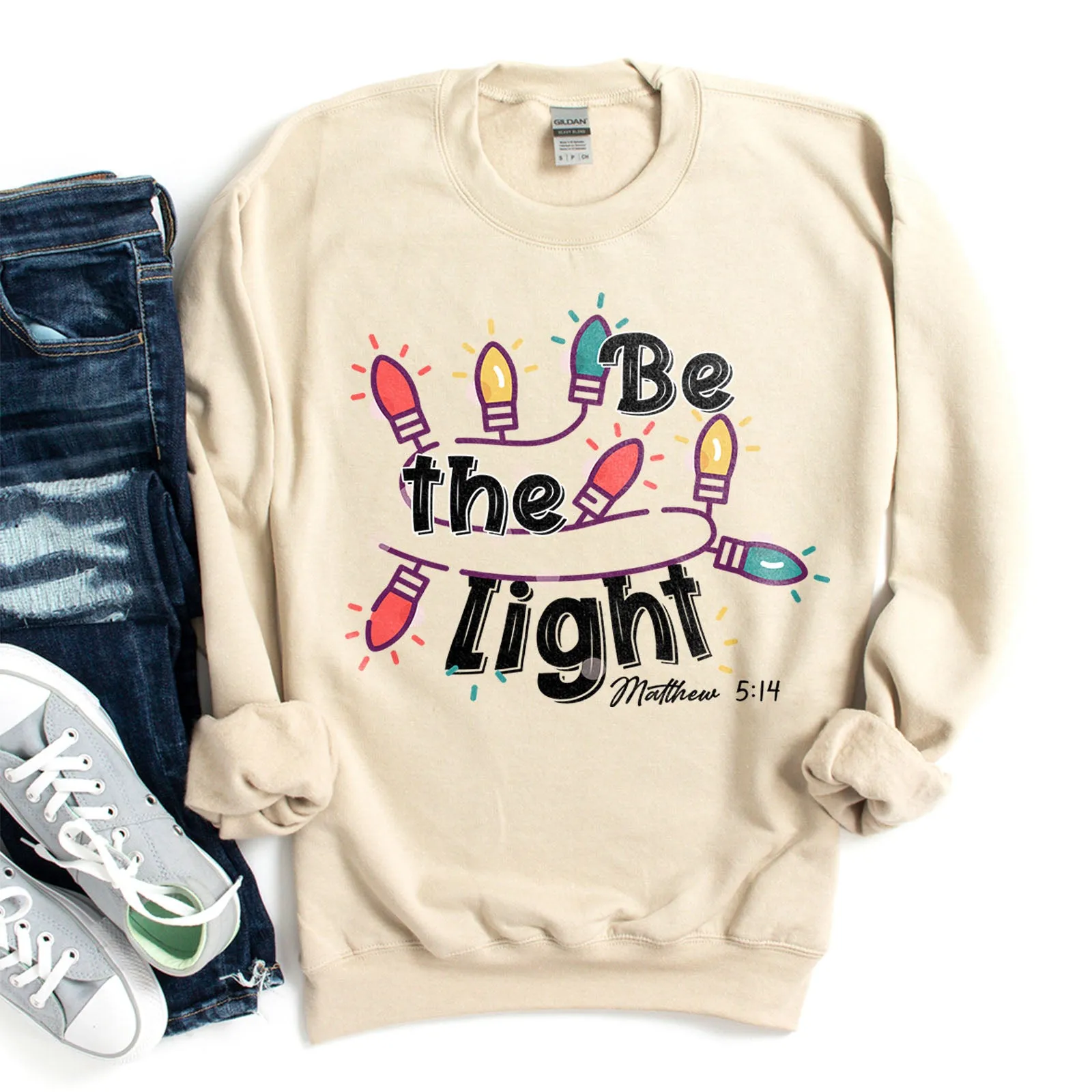 Be The Light Christmas Lights Sweatshirt sold by Faithful and Co.