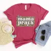 This Mama Prays Tee sold by Faithful and Co.