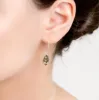 Elegant Twist Drop Earrings in Silver and Green Amber sold by Henryka