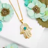 Hamsa Hand Necklace in Silver with 24ct Gold & Turquoise sold by Henryka