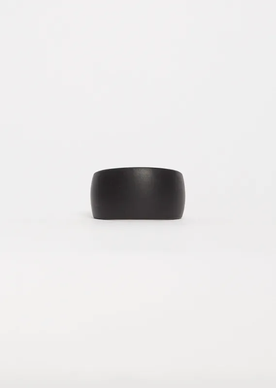 Curved Coated Bracelet — Black sold by La Garconne