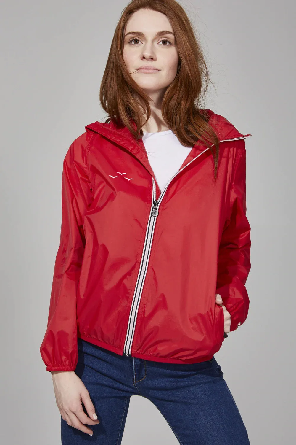 Women's red full zip packable rain jacket and windbreaker sold by Lazypants
