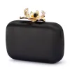 ADELE Orchid Lock Clutch sold by Olga Berg