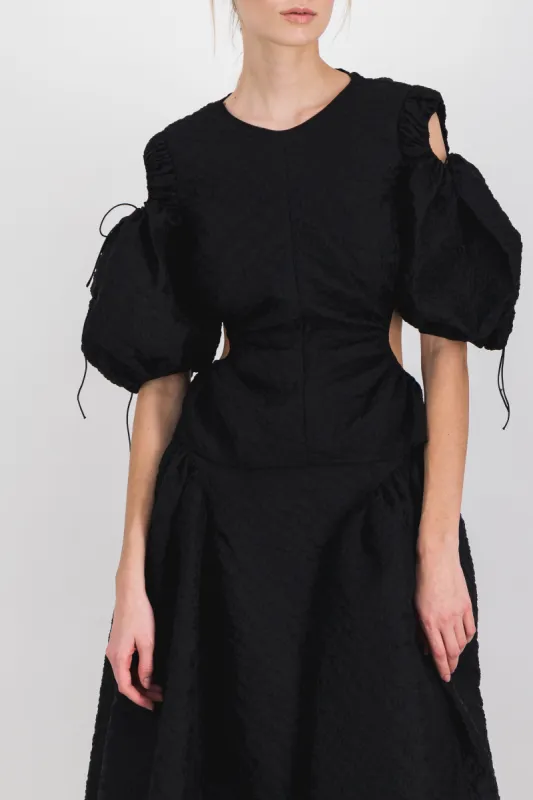 Cut-out puff sleeve matelassé top sold by Renaisa