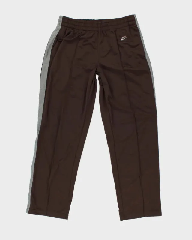 Vintage 2000's Nike Pleated Open Cuff Tracksuit Bottoms - L sold by Rokit