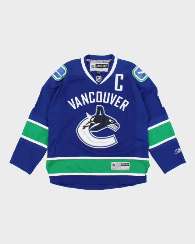 Vintage 90's Vancouver Canucks NHL Oversized Hockey Jersey - M made by Reebok