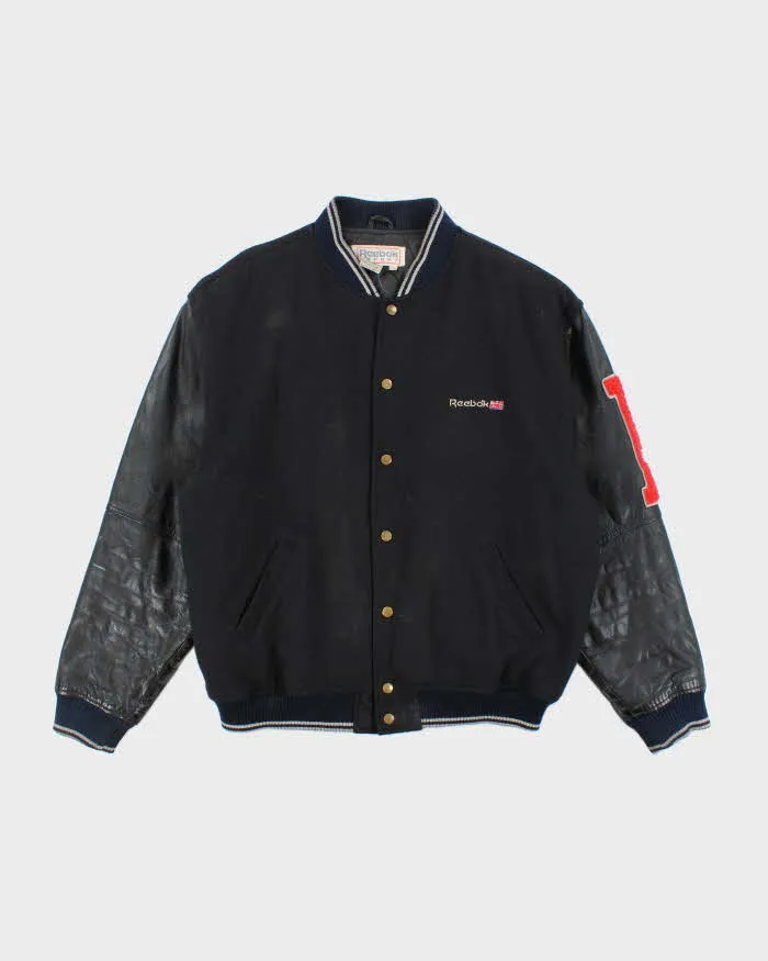 Vintage 80's Reebok Leather Heavyweight Spell Out Varsity Jacket - L sold by Rokit