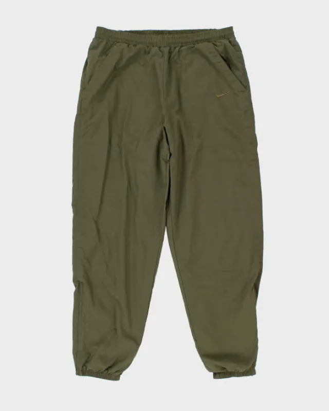 Vintage 1990s Khaki Nike Loose Fit Tracksuit Bottoms - W36 L32 sold by Rokit