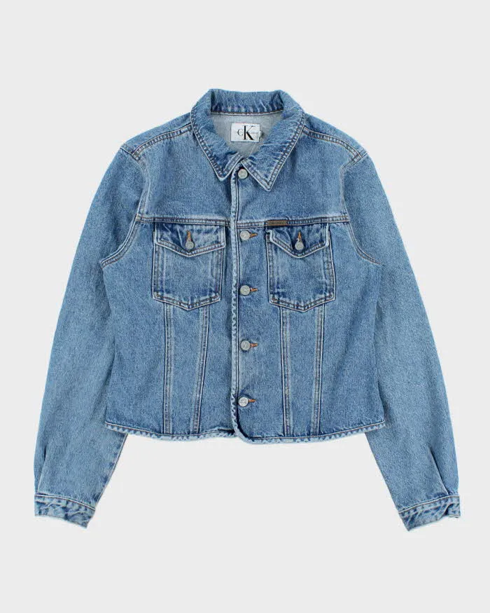 Vintage 1990s Calvin Klein Women's Medium Wash Cropped Denim Jacket - L sold by Rokit
