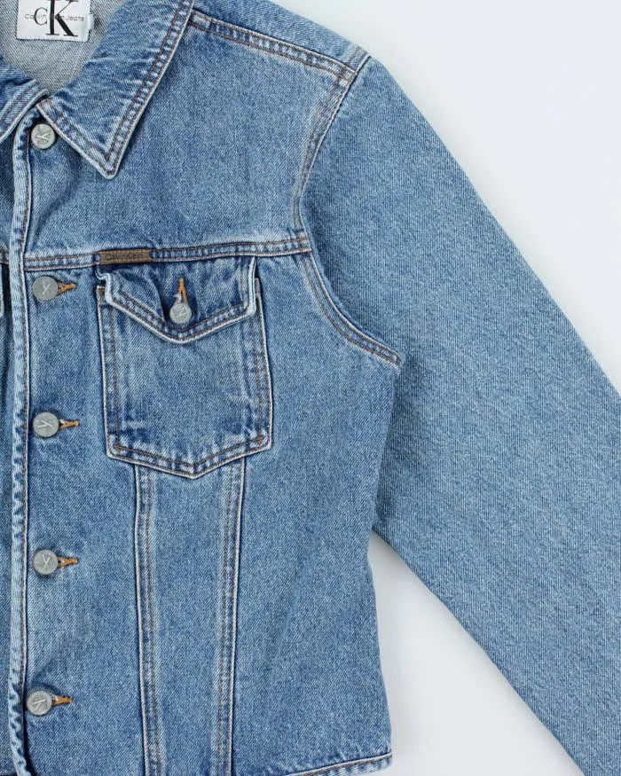 Vintage 1990s Calvin Klein Women's Medium Wash Cropped Denim Jacket - L sold by Rokit product image thumbnail 3