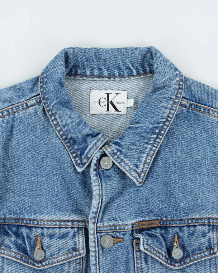 Vintage 1990s Calvin Klein Women's Medium Wash Cropped Denim Jacket - L sold by Rokit product image thumbnail 5