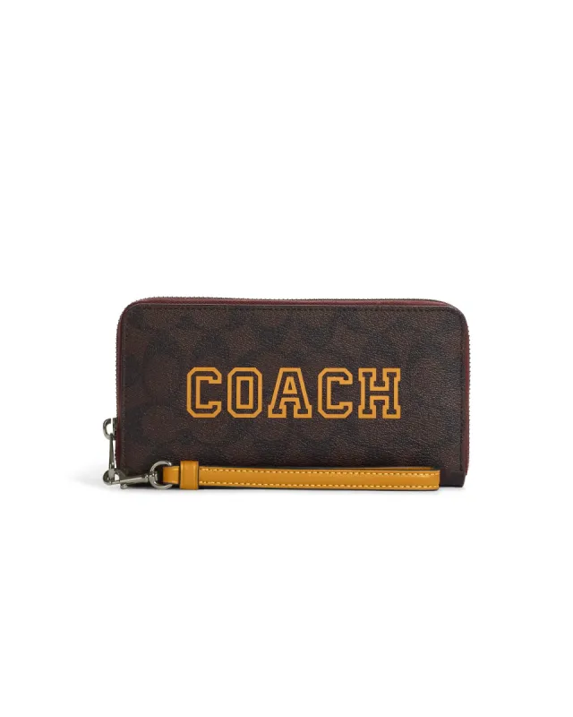 Coach Women's Brown & Buttercup Long Zip Around Wallet In Signature Canvas With Varsity Motif sold by Ruumur