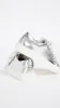 Tory Burch
Tory Sport Ruffle Sneaker sold by Ruumur