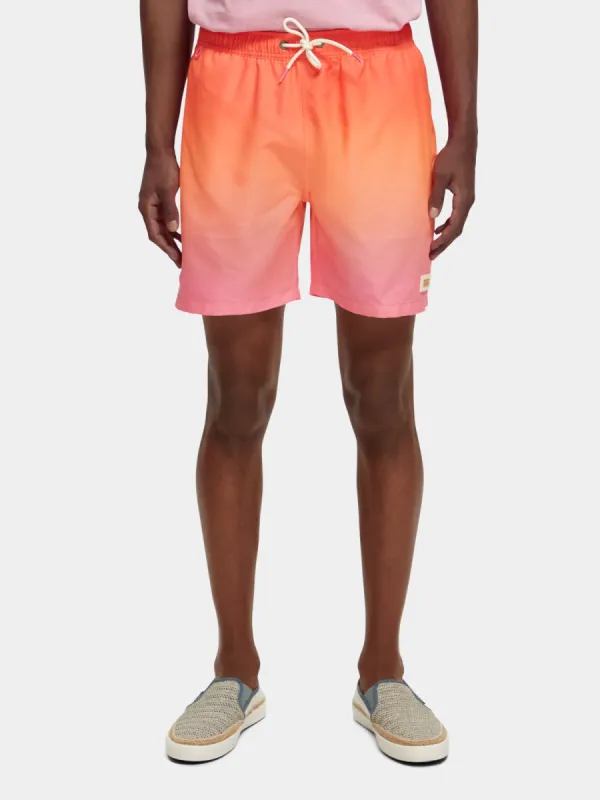Mid-length magic printed swimshorts sold by Scotch and Soda
