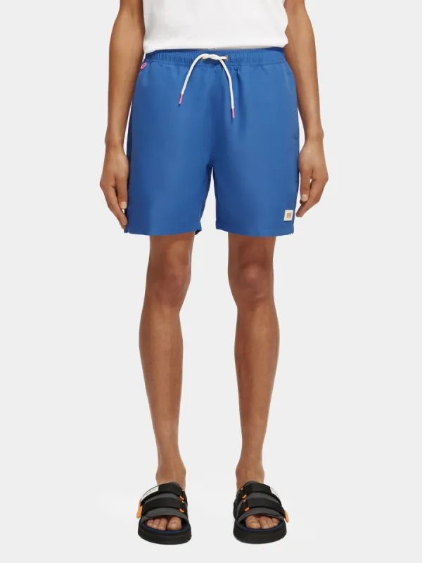 Mid-length magic printed swimshorts sold by Scotch and Soda