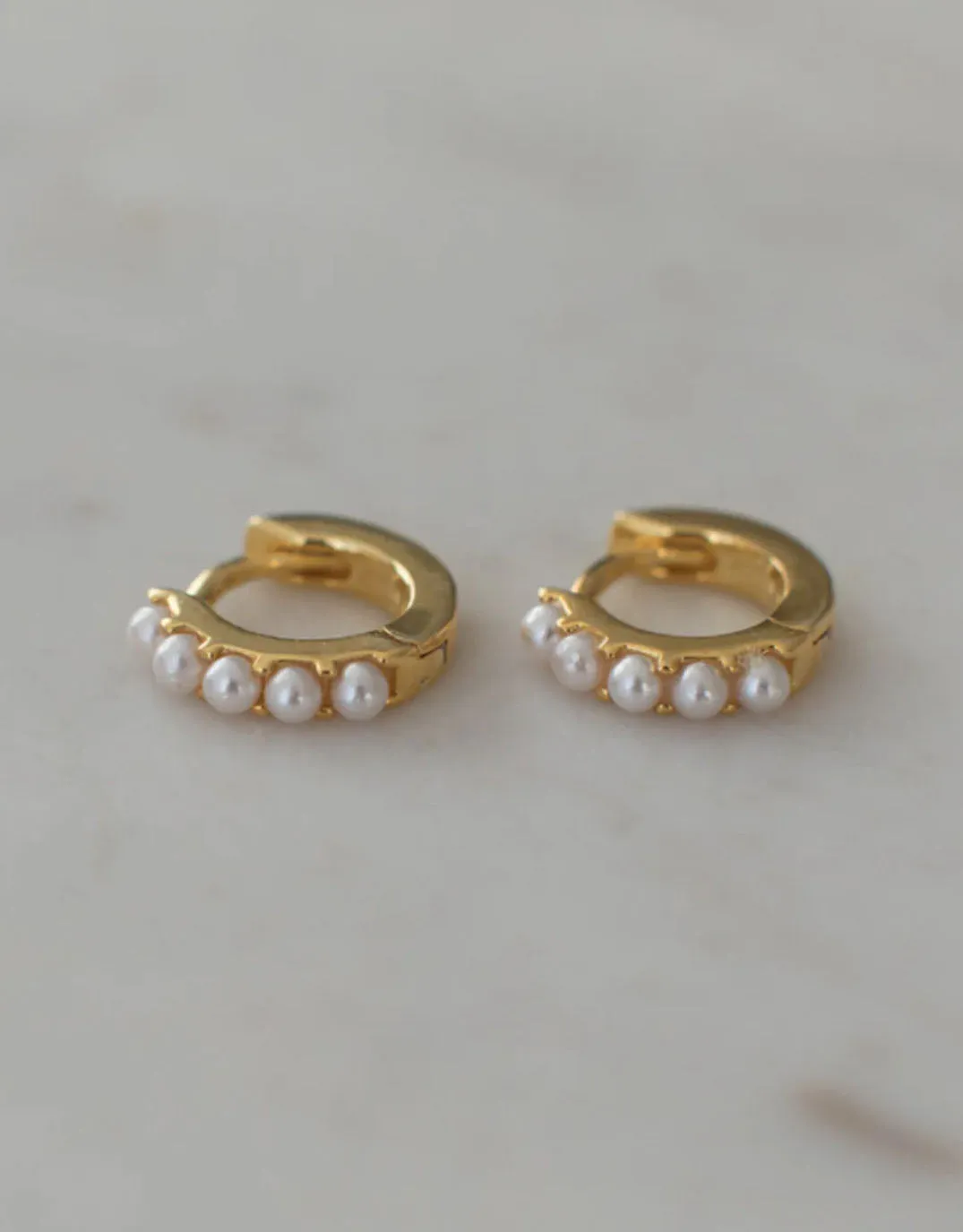 Mini Pearl Huggie Gold Earrings sold by White & Co