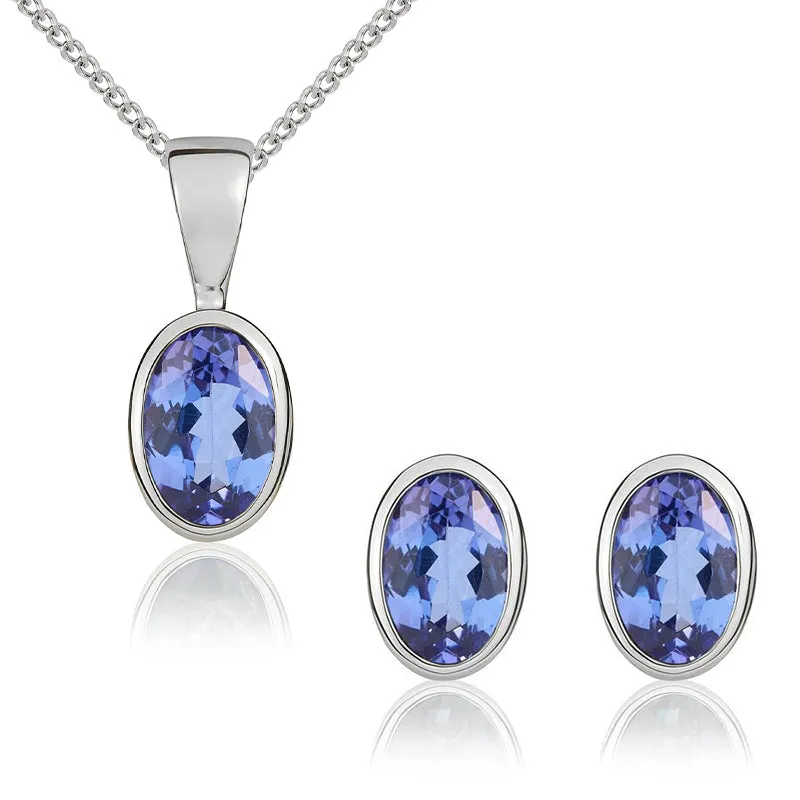 9ct White Gold Tanzanite 6x4mm Oval Rub Over Set Pendant and Stud Earrings Set sold by Jura Watches
