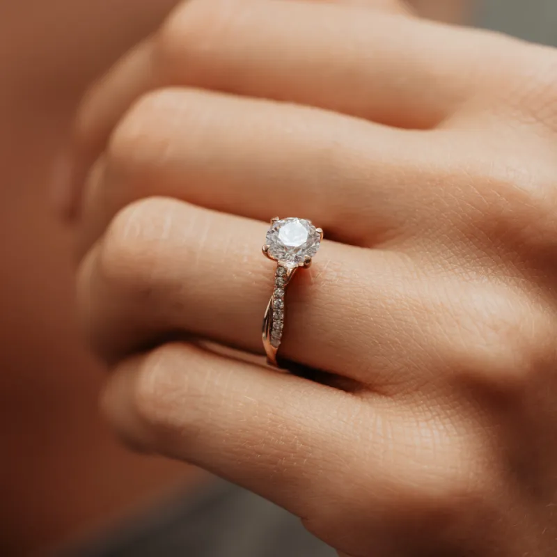 The Mika Ring | Moissanite & Diamond Twisted Shoulder Set Engagement Solitaire sold by Ethica Diamonds