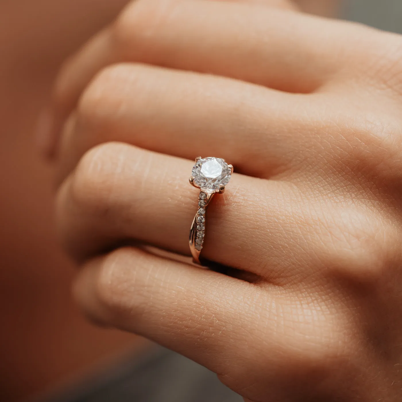 The Mika Ring | Moissanite & Diamond Twisted Shoulder Set Engagement Solitaire sold by Ethica Diamonds