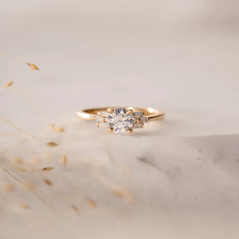 The Tanya Ring | Round Moissanite & Diamond Baguette Accented Art Deco Engagement sold by Ethica Diamonds