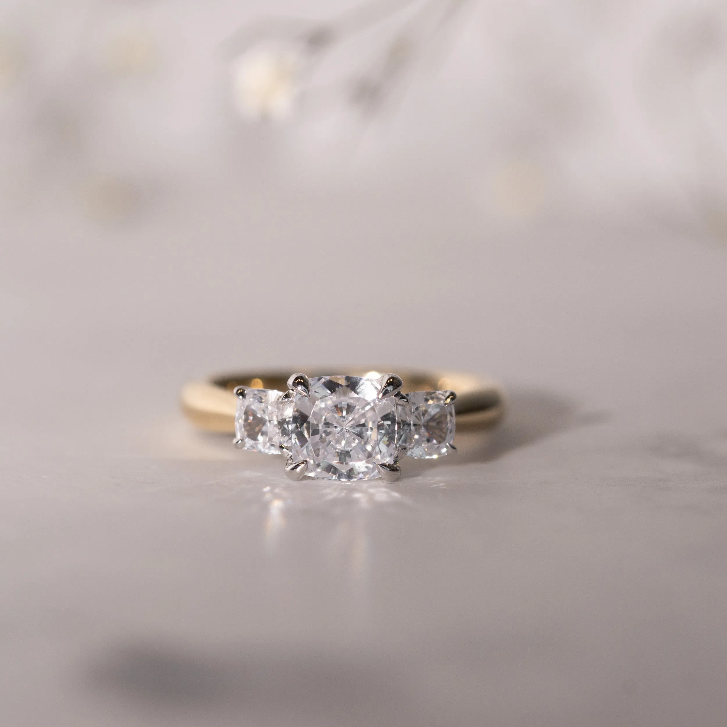 The Lara | Lab Diamond Cushion Cut Trilogy Hidden Halo Engagement Ring sold by Ethica Diamonds